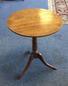 A Victorian mahogany circular tripod table on thre