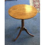 A Victorian mahogany circular tripod table on thre