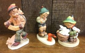 A group of three Hummel figures. Est. £15 - £20.