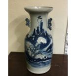 A tall Chinese blue and white vase decorated with