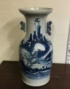 A tall Chinese blue and white vase decorated with