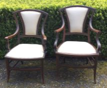 A pair of Edwardian upholstered armchairs. Est. £6
