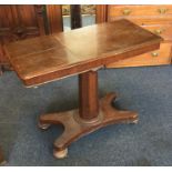 A mahogany hinged top table on four spreading supp