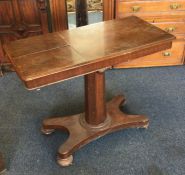 A mahogany hinged top table on four spreading supp