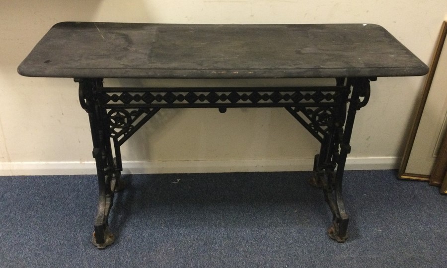 A small rectangular garden table on cast iron base