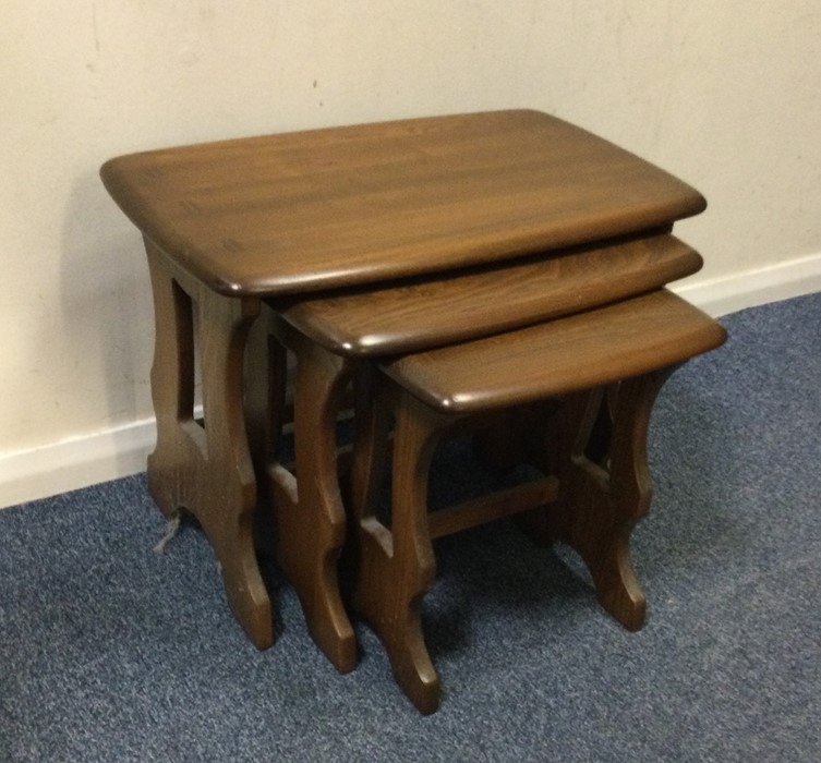 A good nest of Ercol style tables of shaped form.