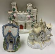 A group of three Staffordshire houses. Est. £20 -