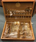 An extensive gold plated cutlery service in box. E