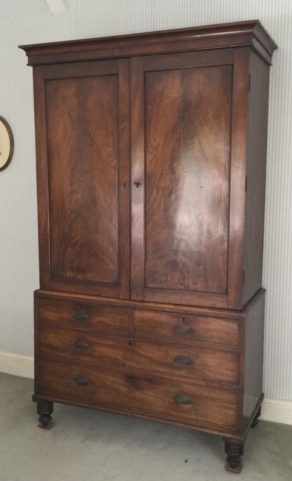 A good tall early Victorian four drawer linen pres