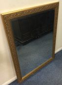 A large gilt mirror with oak leaf border. Est. £30