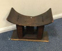 A tribal stool of stylised form. Est. £30 - £50.