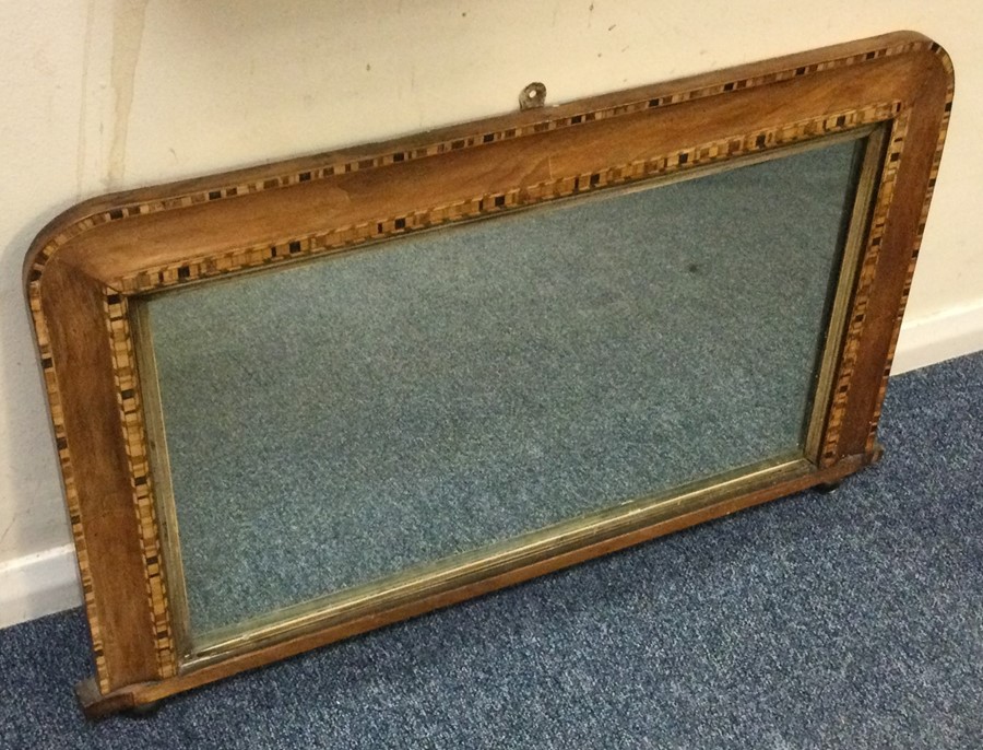 A large parquetry mounted mirror with inlaid decor