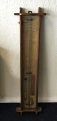 An oak cased barometer of stylised form. Est. £50