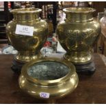 A good pair of Chinese brass mounted vases on wooden s