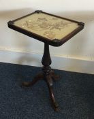 A rectangular top occasional table with tapestry i