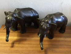 A pair of bronze figures of elephants in standing