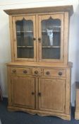 A tall pine two door and three drawer glazed bookc