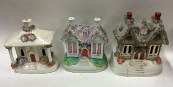 A group of three Staffordshire houses. Est. £20 -