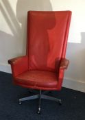 A retro red leather swivel chair. Est. £30 - £50.