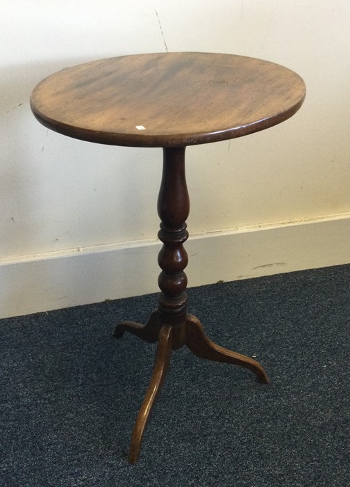 A Victorian circular occasional table on three swe