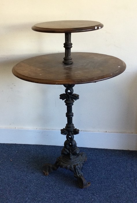 A large cast iron two tier drink's table of circul
