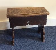 A small oak stool with carved decoration. Est. £20