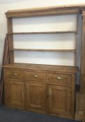 A pine three drawer dresser with open back. Est. £
