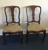 A pair of Dutch marquetry inlaid chairs with slip-