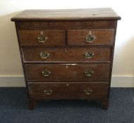 A Georgian oak chest of five drawers with panelled