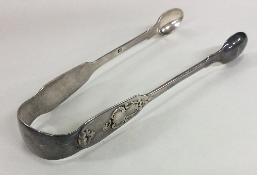 A pair of attractive silver sugar tongs with scrol