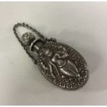 An Indian silver scent bottle chased with flowers