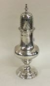 A large George III silver sugar caster with reeded