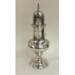 A large George III silver sugar caster with reeded