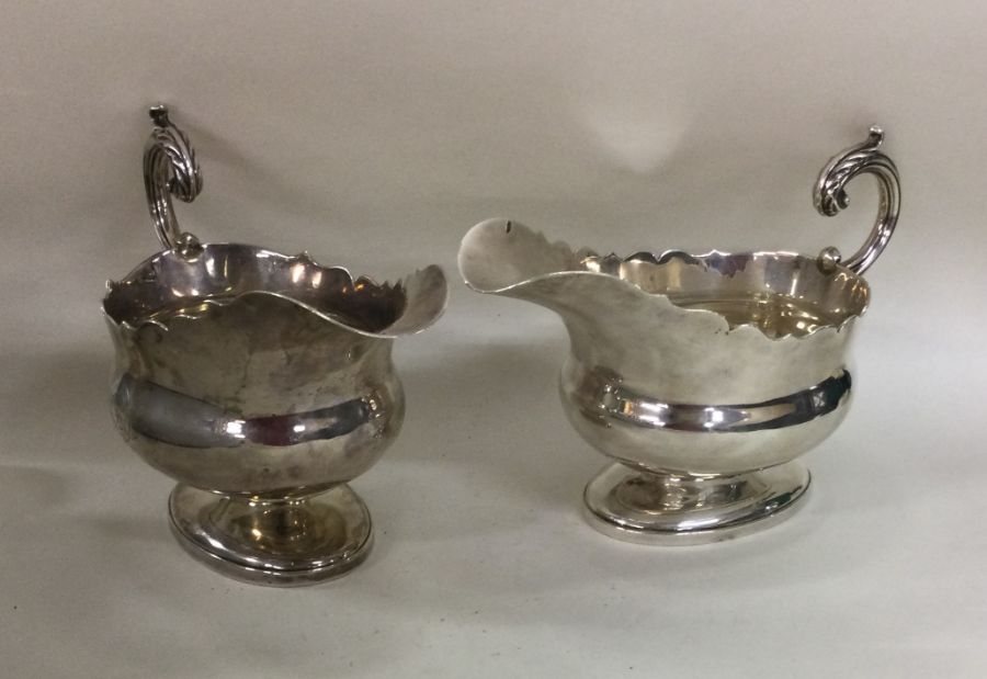 A good pair of crested silver sauce boats with car