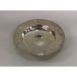 A large circular silver armada dish of typical for