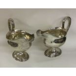 A heavy pair of Georgian silver sauce boats with b