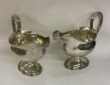 A heavy pair of Georgian silver sauce boats with b