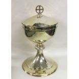 A large silver gilt church chalice with hammered b