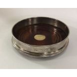 A good silver mounted wine coaster with gold inset