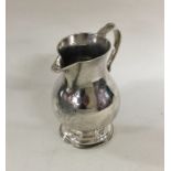 A heavy Georgian silver sparrow beak cream jug of