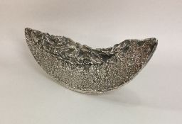 A silver model of a slice of melon with textured d