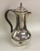 A Georgian baluster shaped silver jug with cane ha