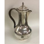 A Georgian baluster shaped silver jug with cane ha
