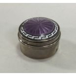 A circular silver and enamelled hinged top box. Bi