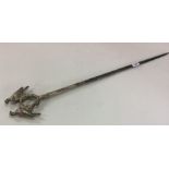 A large silver plated meat skewer cast with birds