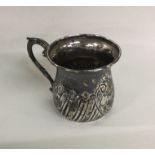 A small silver christening cup with fluted decorat
