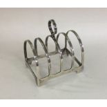 A small Edwardian silver five bar toast rack on br