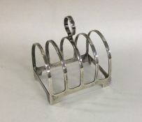 A small Edwardian silver five bar toast rack on br