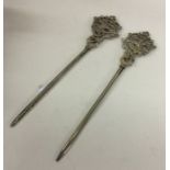 A good pair of silver plated meat skewers cast wit