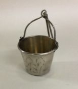 A tapering Russian silver tea strainer with gilt h